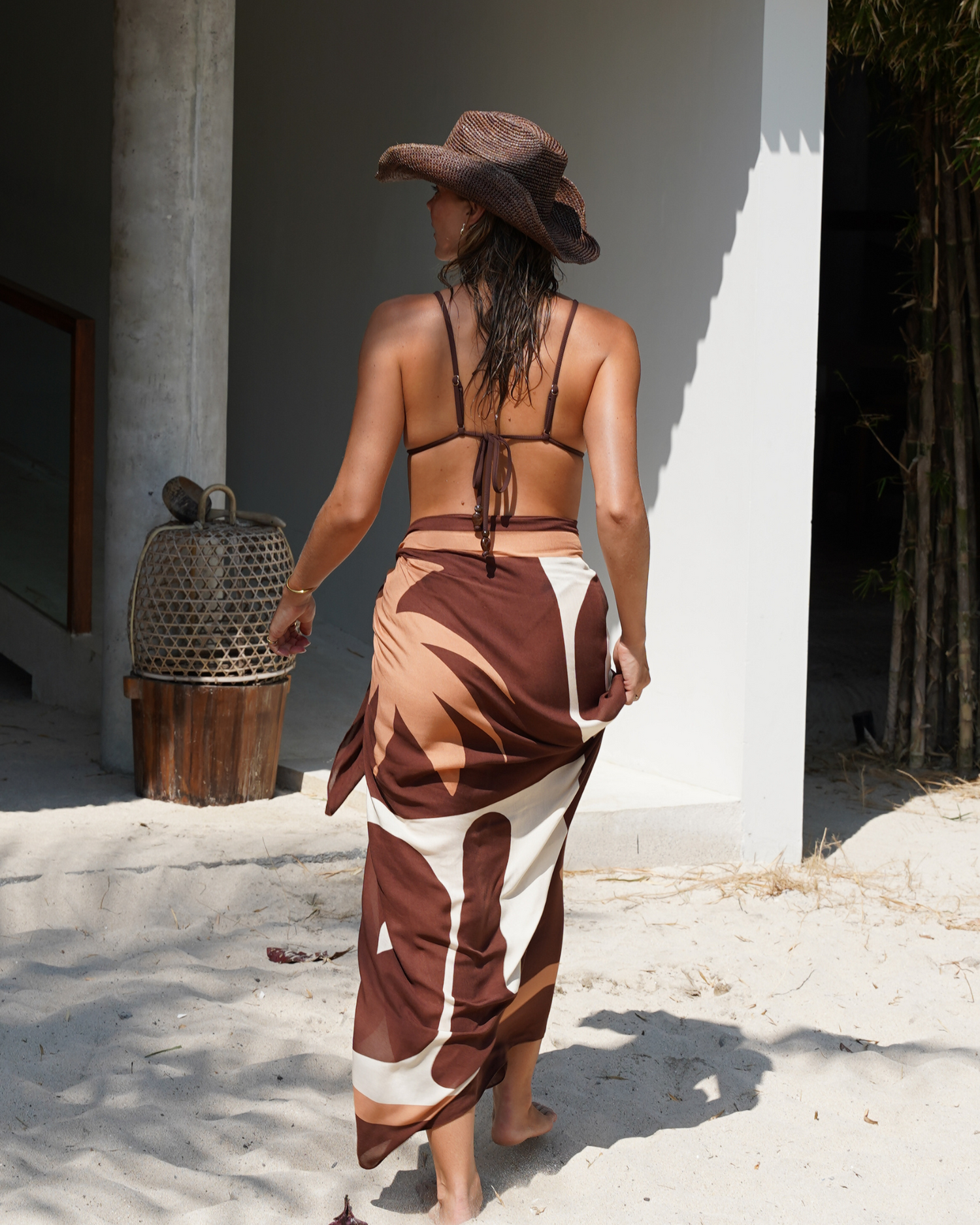 Minimal triangle bikini top in chocolate ribbed fabric with luxe gold hardware and string back detail.