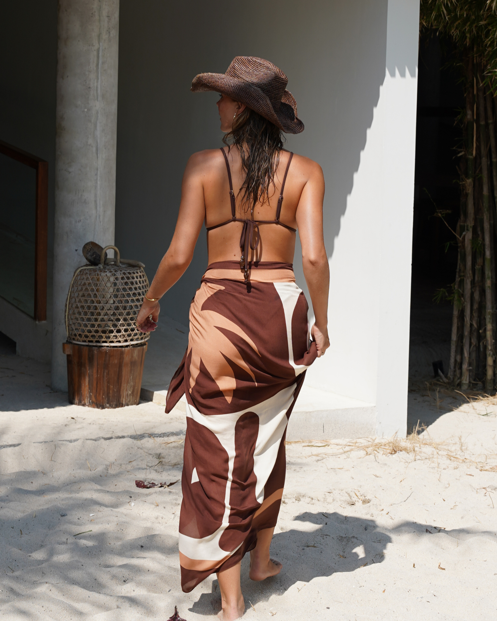 Minimal triangle bikini top in chocolate ribbed fabric with luxe gold hardware and string back detail.