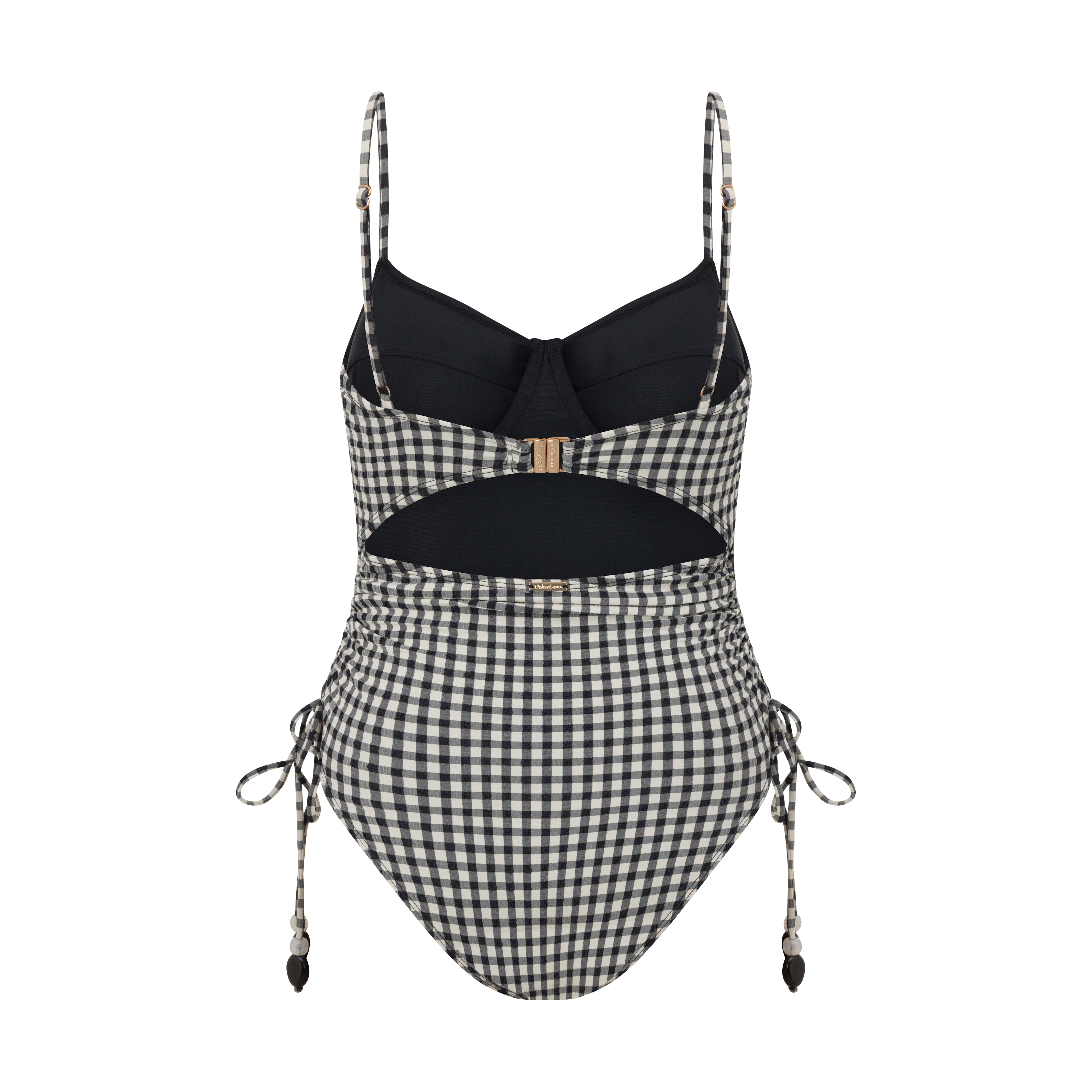 Thin Strap Underwire One Piece in black and cream gingham seersucker, captured by the ocean for elevated beachwear style.