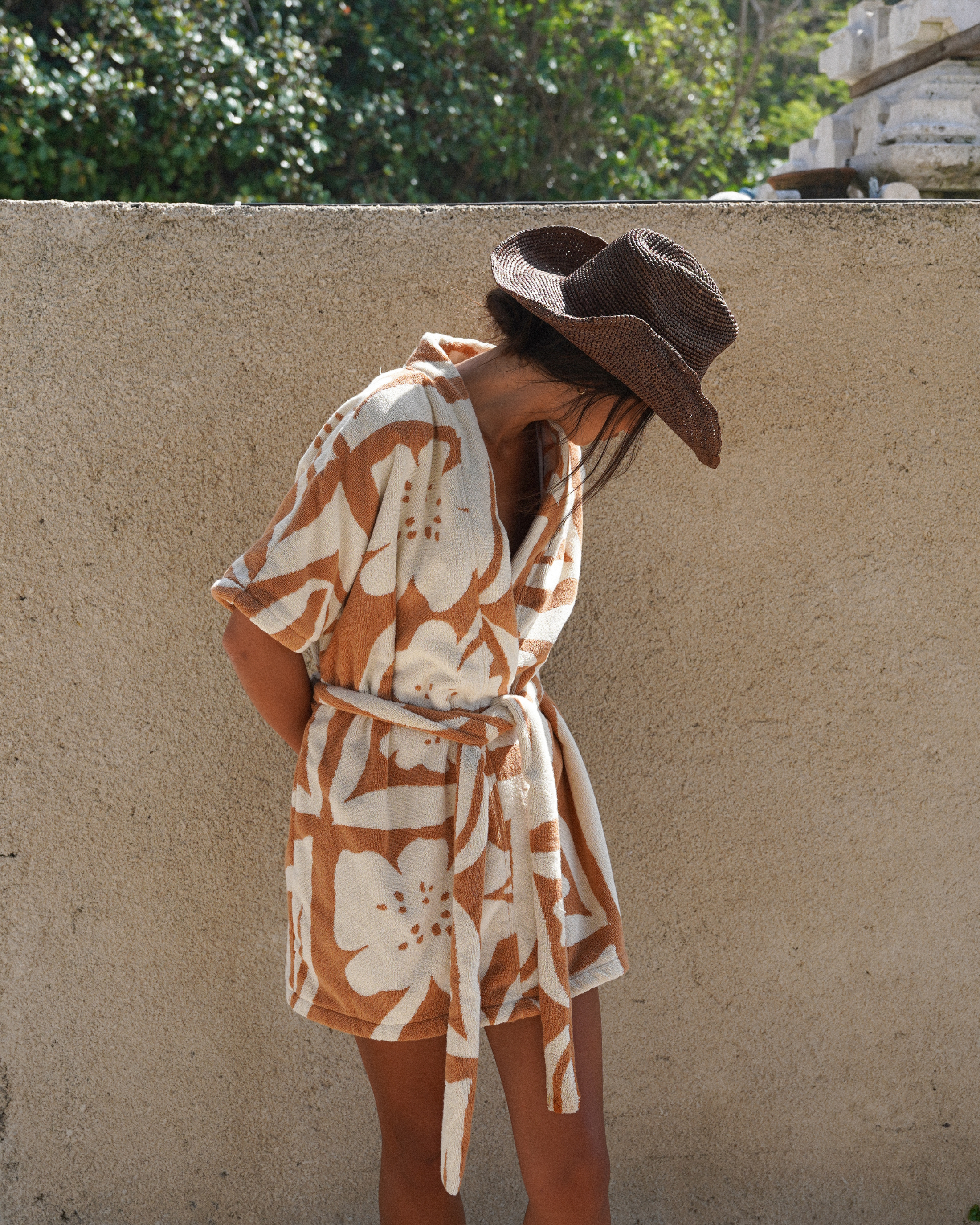 Detail of the Sienna robe’s cotton towelling texture and tonal floral print in beige and caramel hues, combining comfort with understated luxury for warm weather lounging.