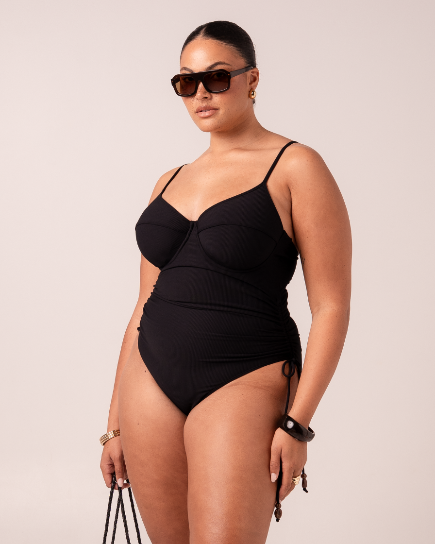 Thin Strap Underwire One Piece in black rib with supportive underwire bust and adjustable beaded side ties