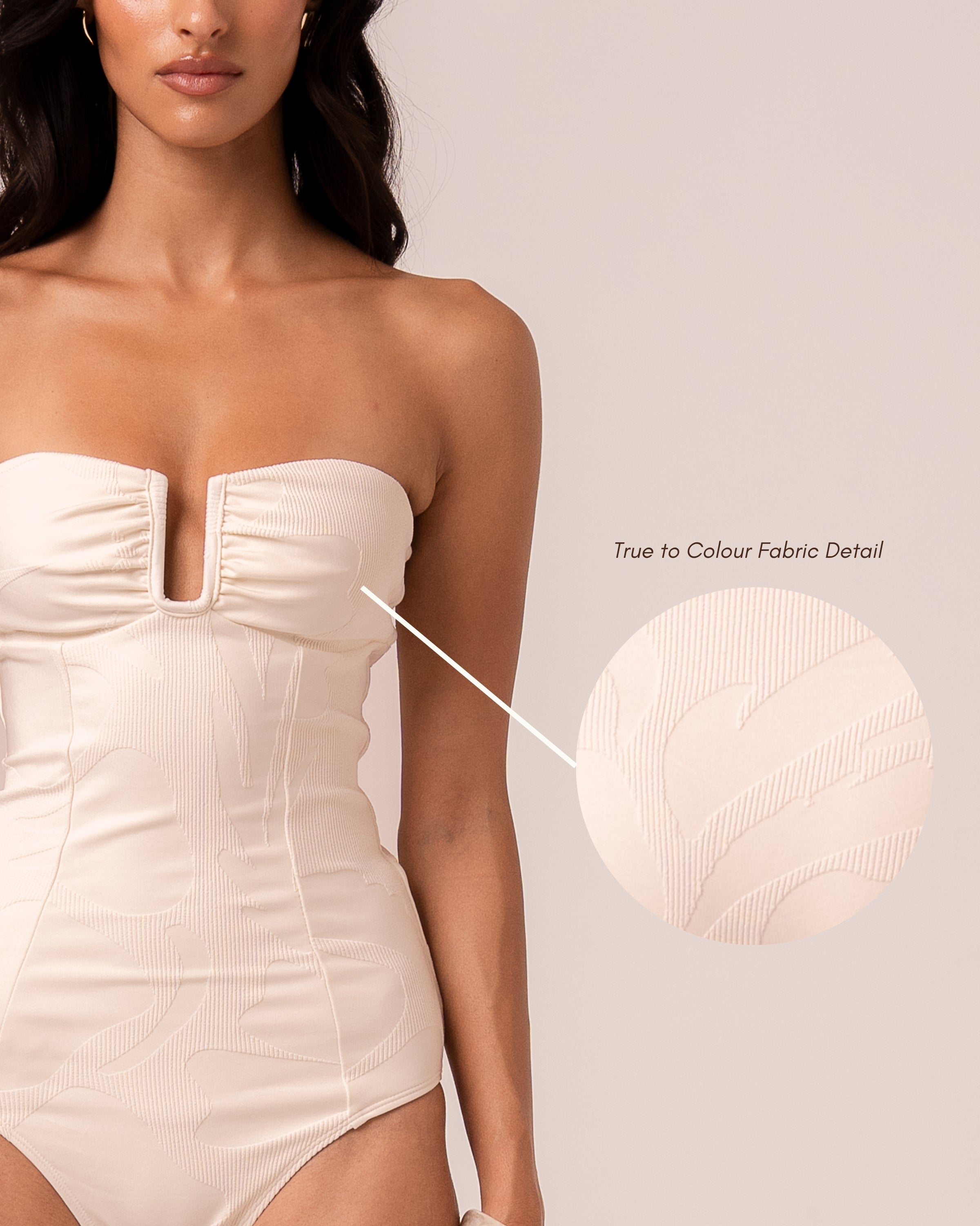 Close-up of the ivory jacquard rib fabric on the bandeau one piece showing the woven floral motif — true to colour fabric detail