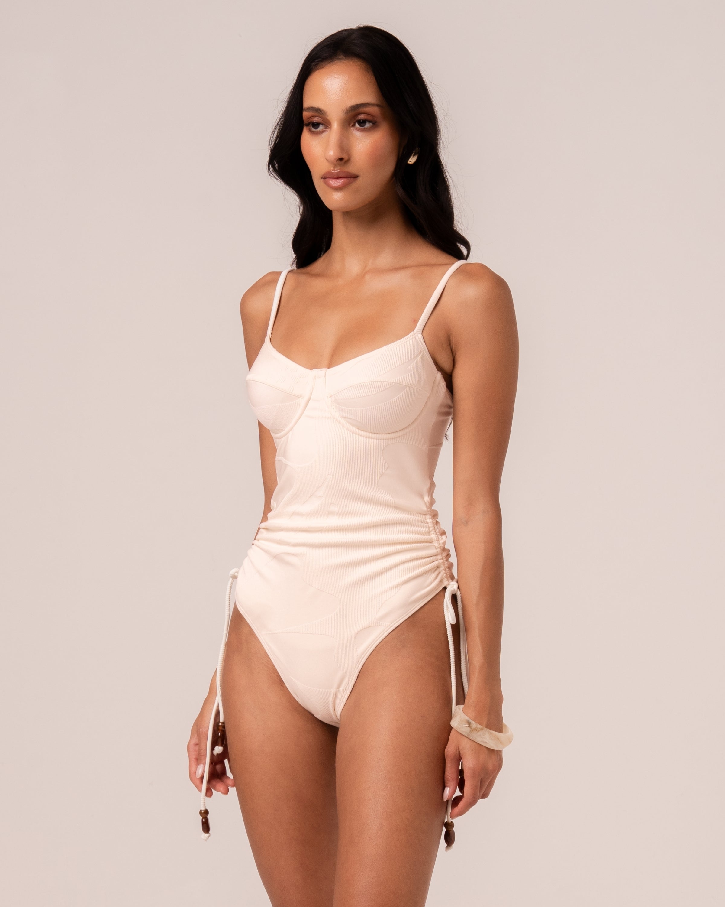Close-up of the ivory jacquard rib fabric on the underwire one piece showing the woven floral motif — true to colour fabric detail