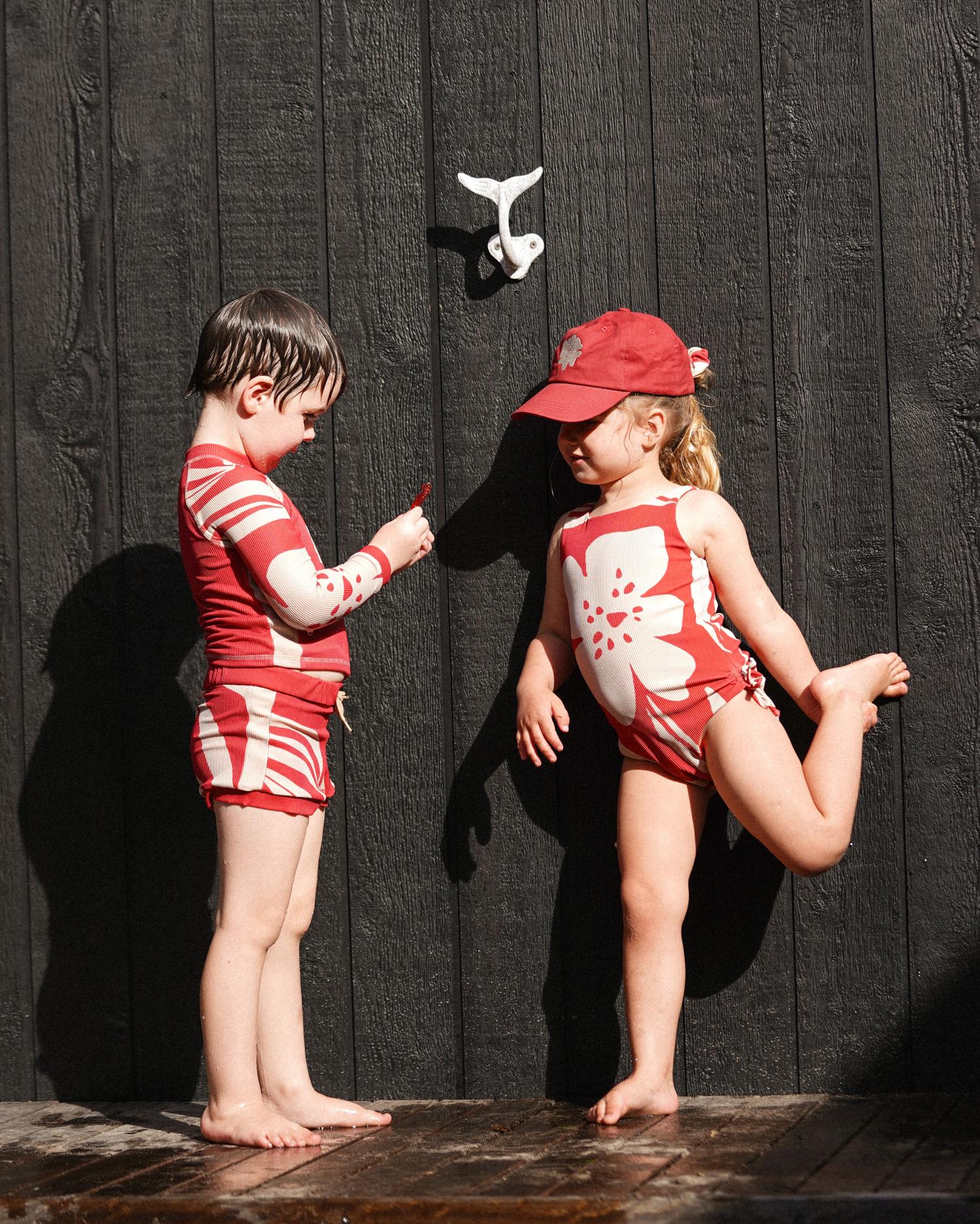 Children’s red floral scoop-neck swimsuit with contrast cream hibiscus design