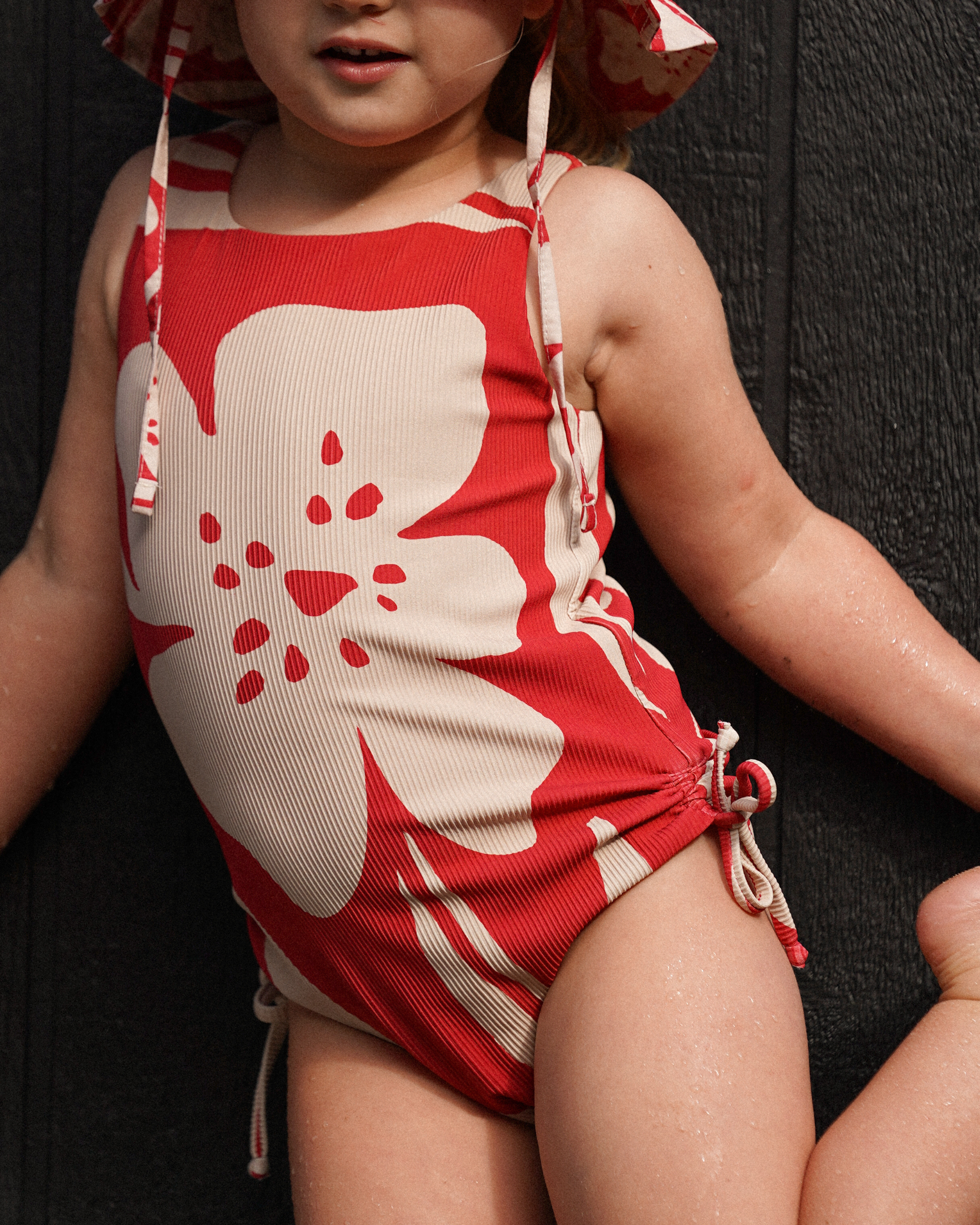 Kids rib red floral swimsuit with side ties from Ochre Lane