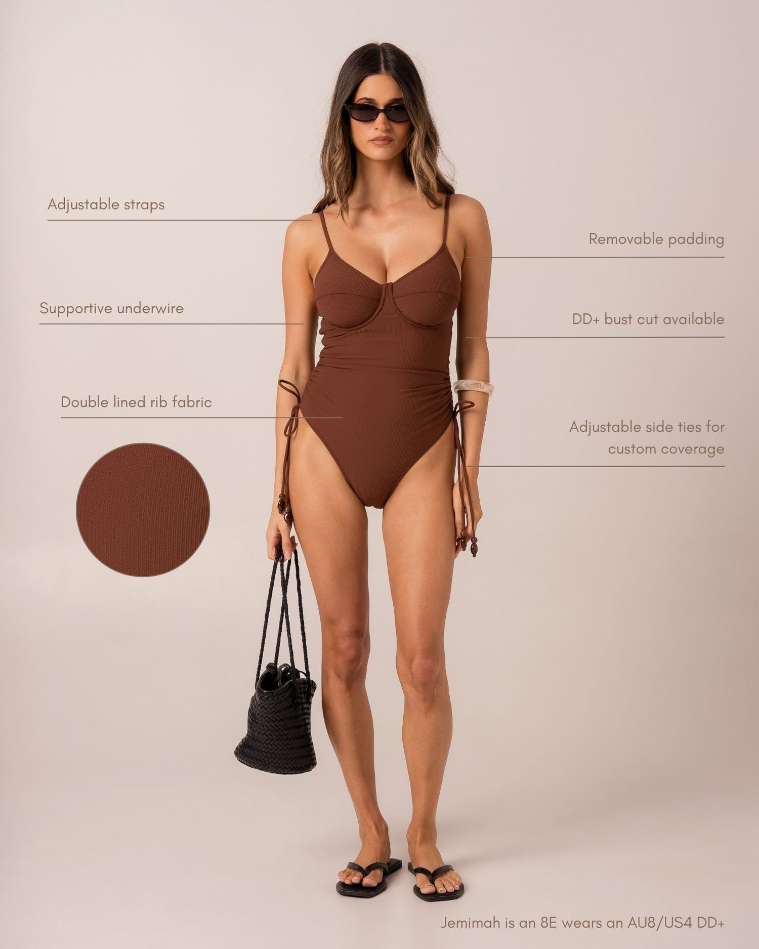 Infographic of a chocolate brown ribbed underwire one-piece swimsuit in studio, highlighting adjustable straps, removable padding, DD+ bust cut and double-lined rib fabric.