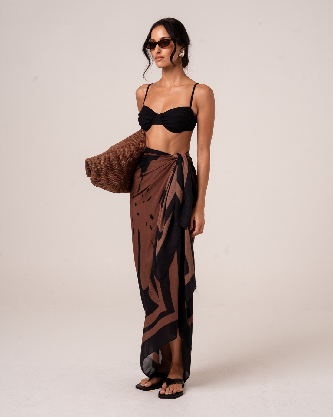 Ochre Lane Alba Sarong in chocolate and black floral print, a lightweight beach cover-up over swimwear