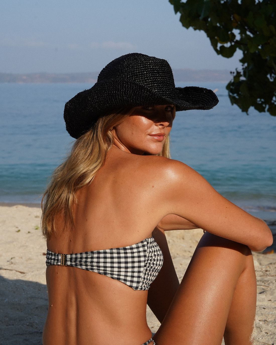 Lightweight black straw cowboy hat with wide brim, perfect for vacation and resort styling.