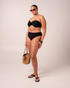 Ochre Lane Bandeau Twist bikini top in black rib with supportive twist front and side boning detail