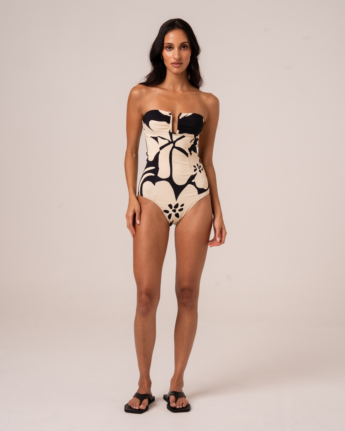 Botanica floral print sculpted bandeau one-piece swimsuit in black and cream, front view studio shot