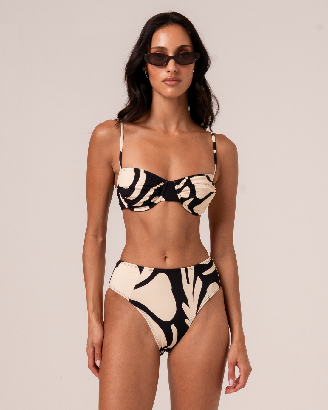 Botanica print ruched bandeau bralette in black and cream with high-waist bikini bottom, front view studio shot