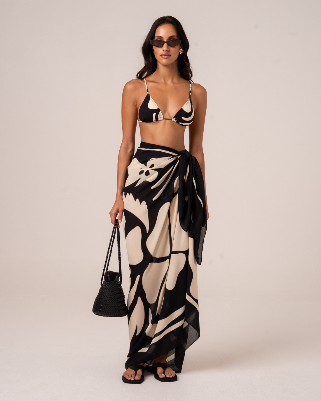 Ochre Lane Botanica Sarong in black and cream floral print, a lightweight beach cover-up over swimwear