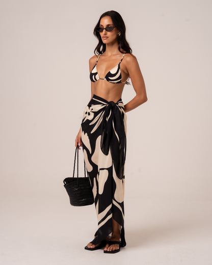 Botanica Sarong in black and cream floral print styled as a wrap skirt over swimwear, sizes 8-22