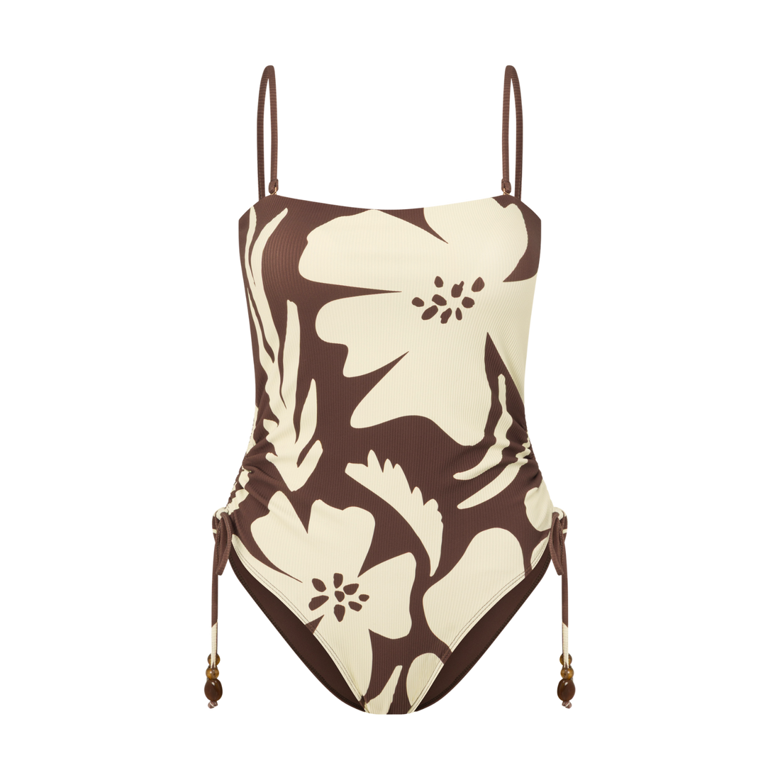 Front view of a brown and cream floral print one-piece swimsuit with thin adjustable straps and a ruched side-tie detail, studio flat lay