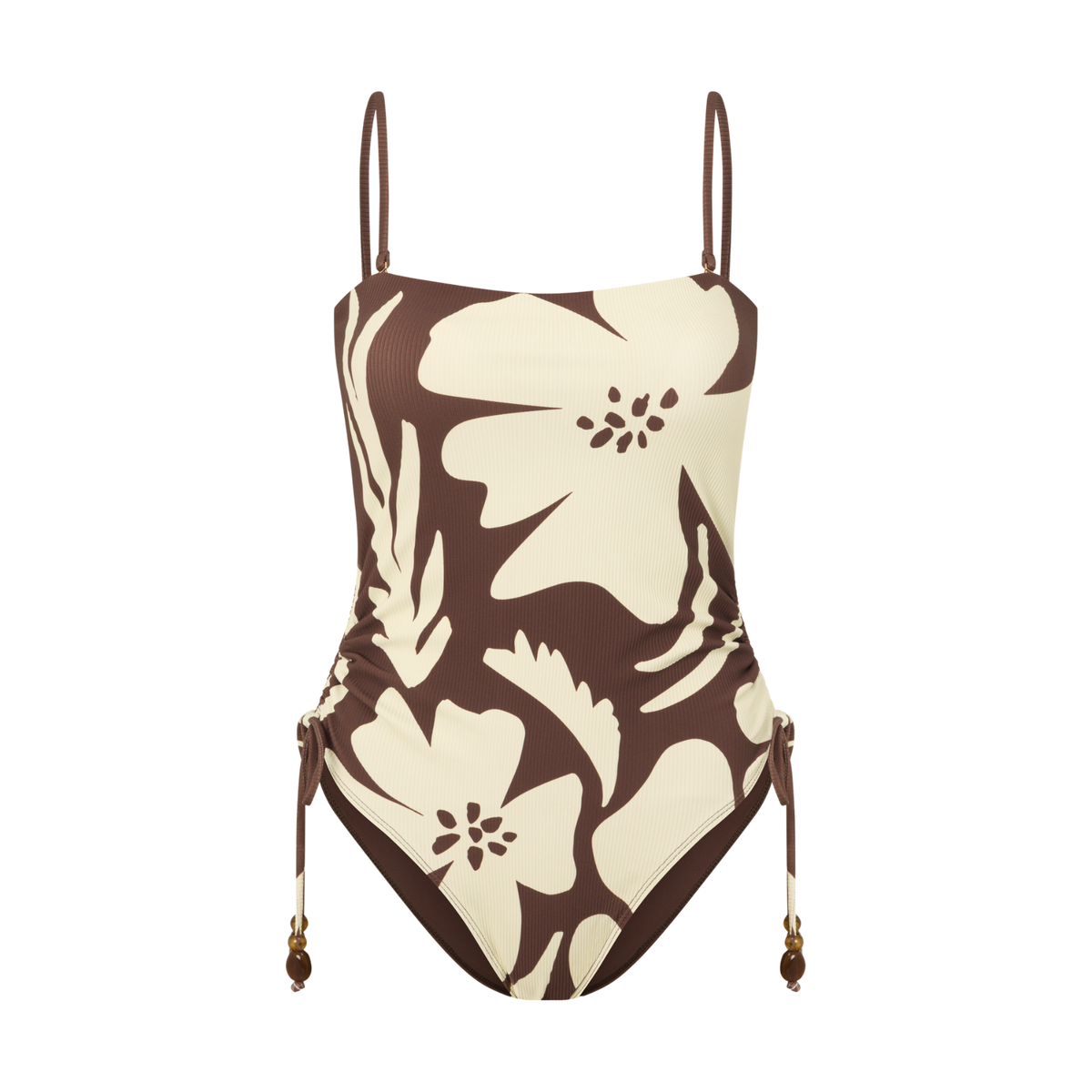 Front view of a brown and cream floral print one-piece swimsuit with thin adjustable straps and a ruched side-tie detail, studio flat lay