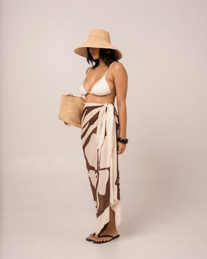 Side view of the brown floral Ibisco Sarong showing the knotted side tie and long fluid drape of the pareo wrap