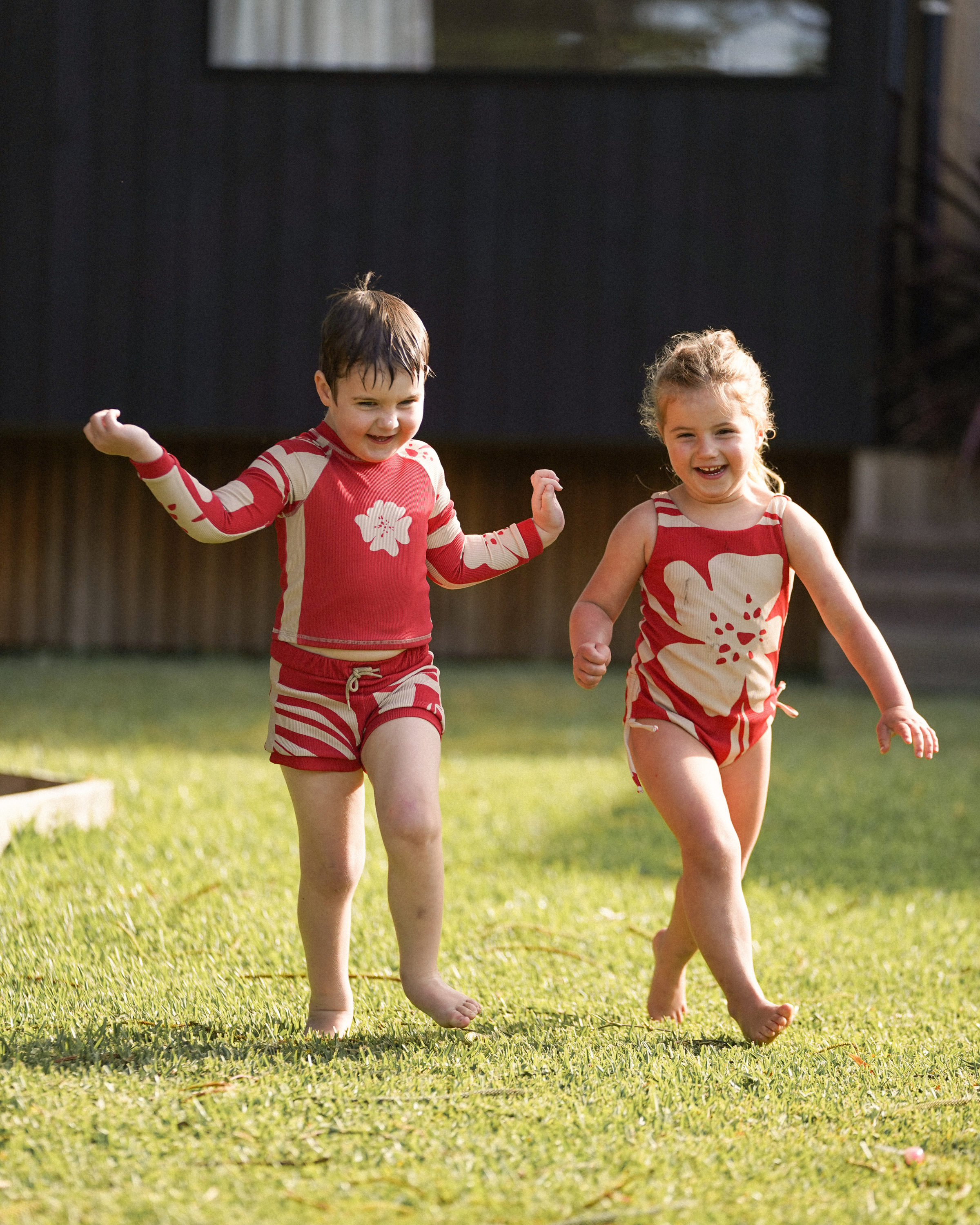 Children’s red floral swim shorts in Solana print with soft waistband