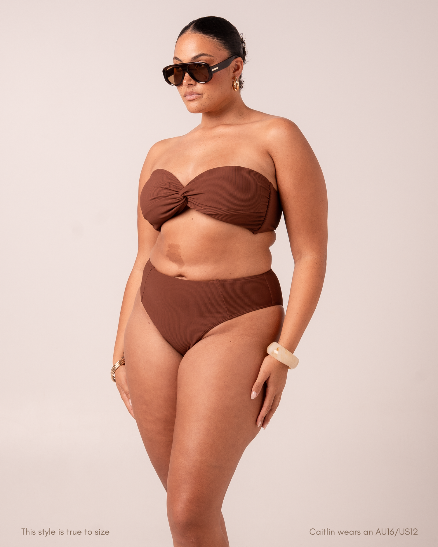 Front view of a curve model wearing a chocolate-brown ribbed splice mid-rise bikini bottom with a matching strapless bandeau top