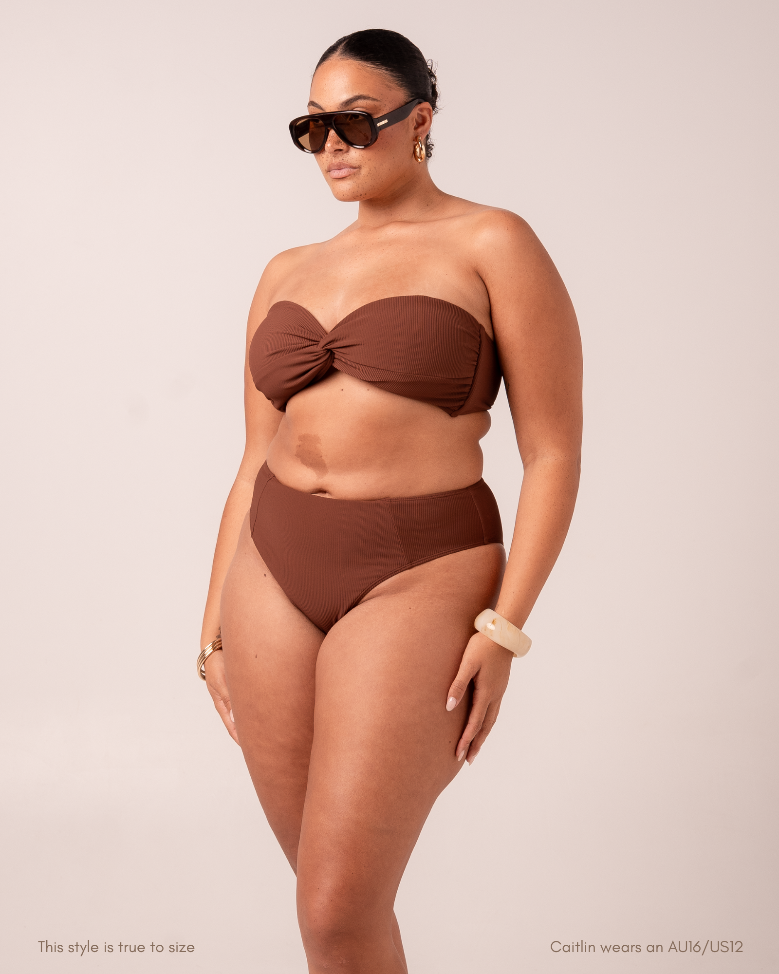 Front view of a curve model wearing a chocolate-brown ribbed splice mid-rise bikini bottom with a matching strapless bandeau top