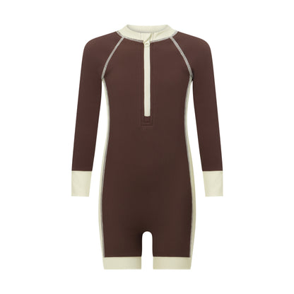 Front view of a chocolate brown kids long sleeve surf suit with a cream zip neck, contrast cuffs and ribbed UPF fabric