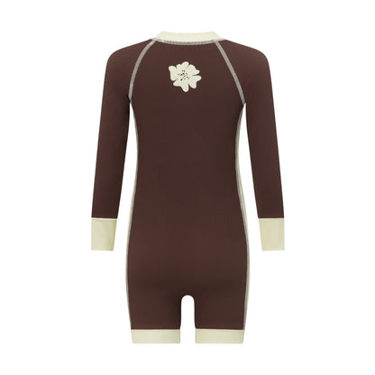Back view of a chocolate brown kids surf suit showing the cream flower graphic between the shoulders and contrast cuffs