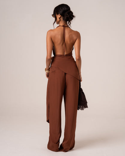 Back view of a chocolate brown halter wrap top showing the deep open back and halter tie