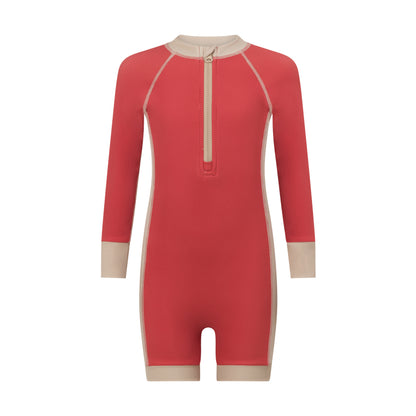 Front view of a coral melon kids long sleeve surf suit with a cream zip neck, contrast panels and ribbed sun-safe fabric