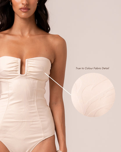 Close-up of the ivory jacquard rib fabric on the bandeau one piece showing the woven floral motif — true to colour fabric detail