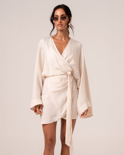 Ivory batwing wrap mini dress with a deep V-neck and self-tie waist, front view — honeymoon resortwear