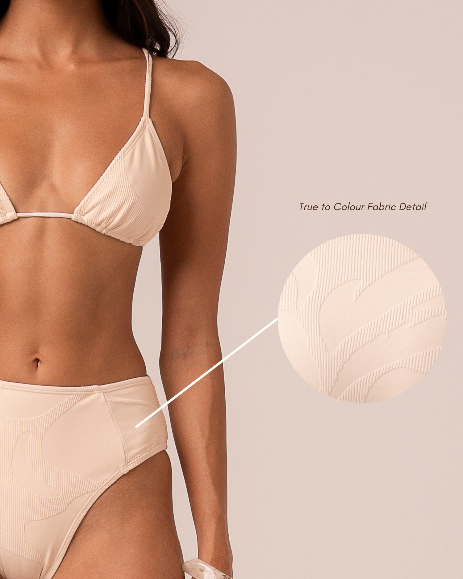 Close-up of the ivory jacquard rib fabric on the mid rise bikini bottom showing the woven floral motif — true to colour fabric detail