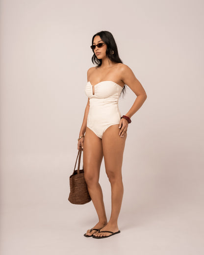 Ivory sculpted bandeau one piece swimsuit showing the V-wire bust and ribbed jacquard side, studio three-quarter view