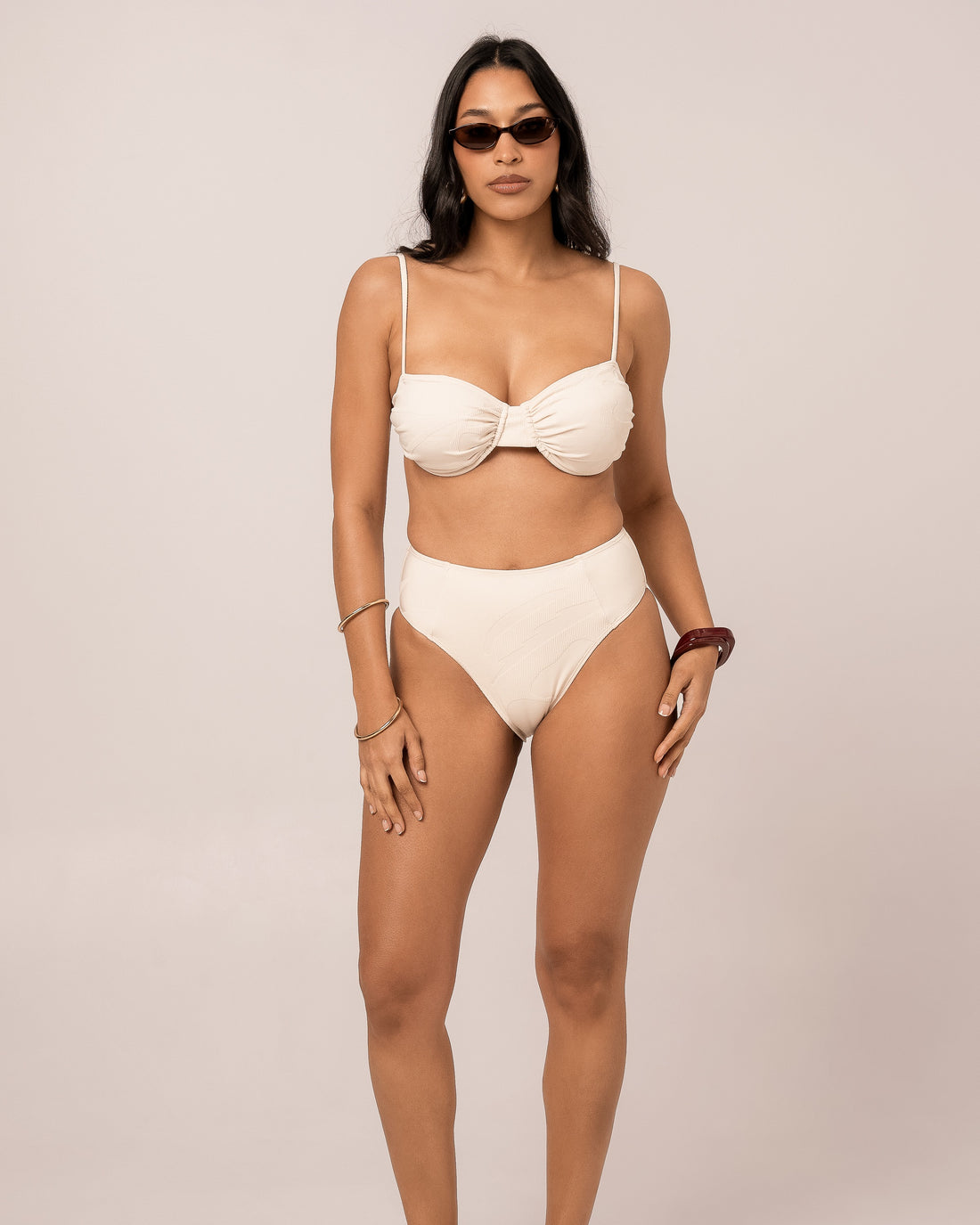 Close cropped view of the ivory soft cup bralette showing the ruched centre and supportive cups on a size 12 fit — studio detail