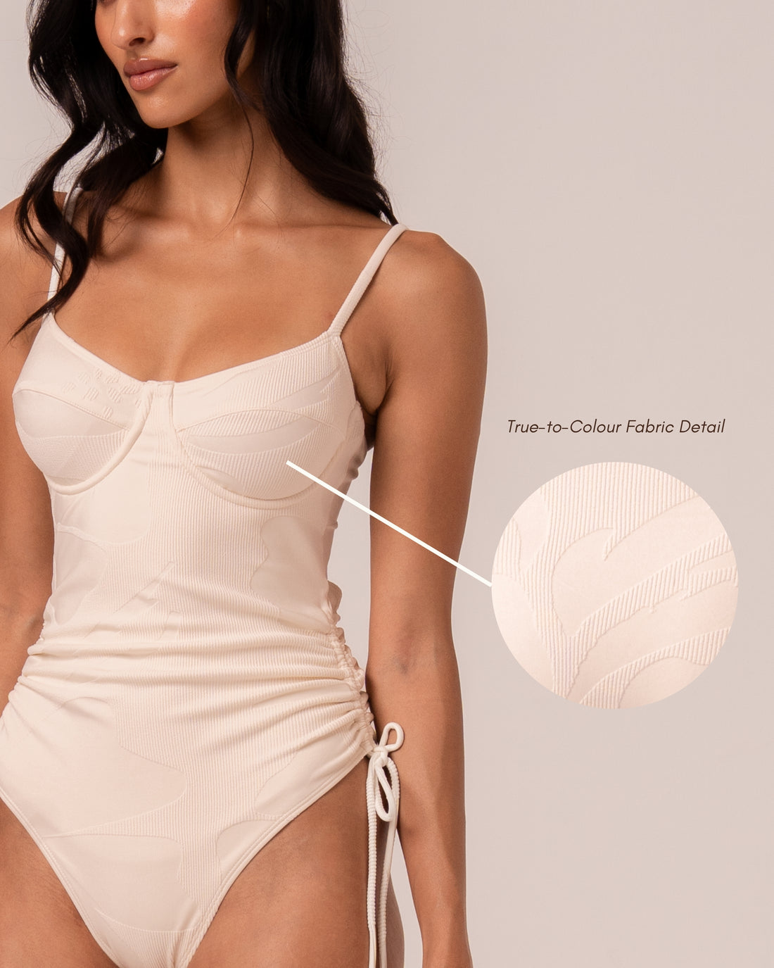 Ivory thin strap underwire one piece swimsuit with ruched adjustable side ties, three-quarter front view