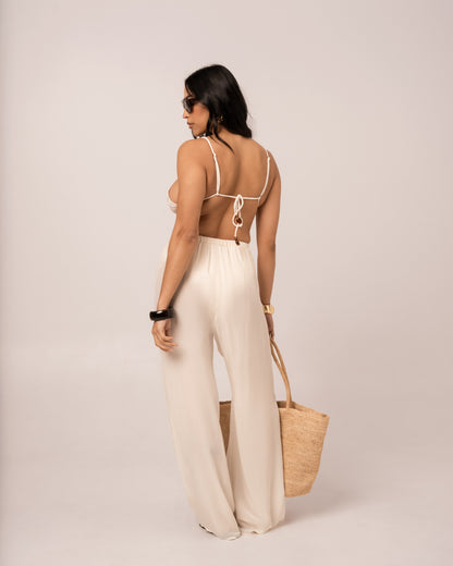 Back view of the ivory wide-leg resort pant with its relaxed drawstring waist and full-length hem