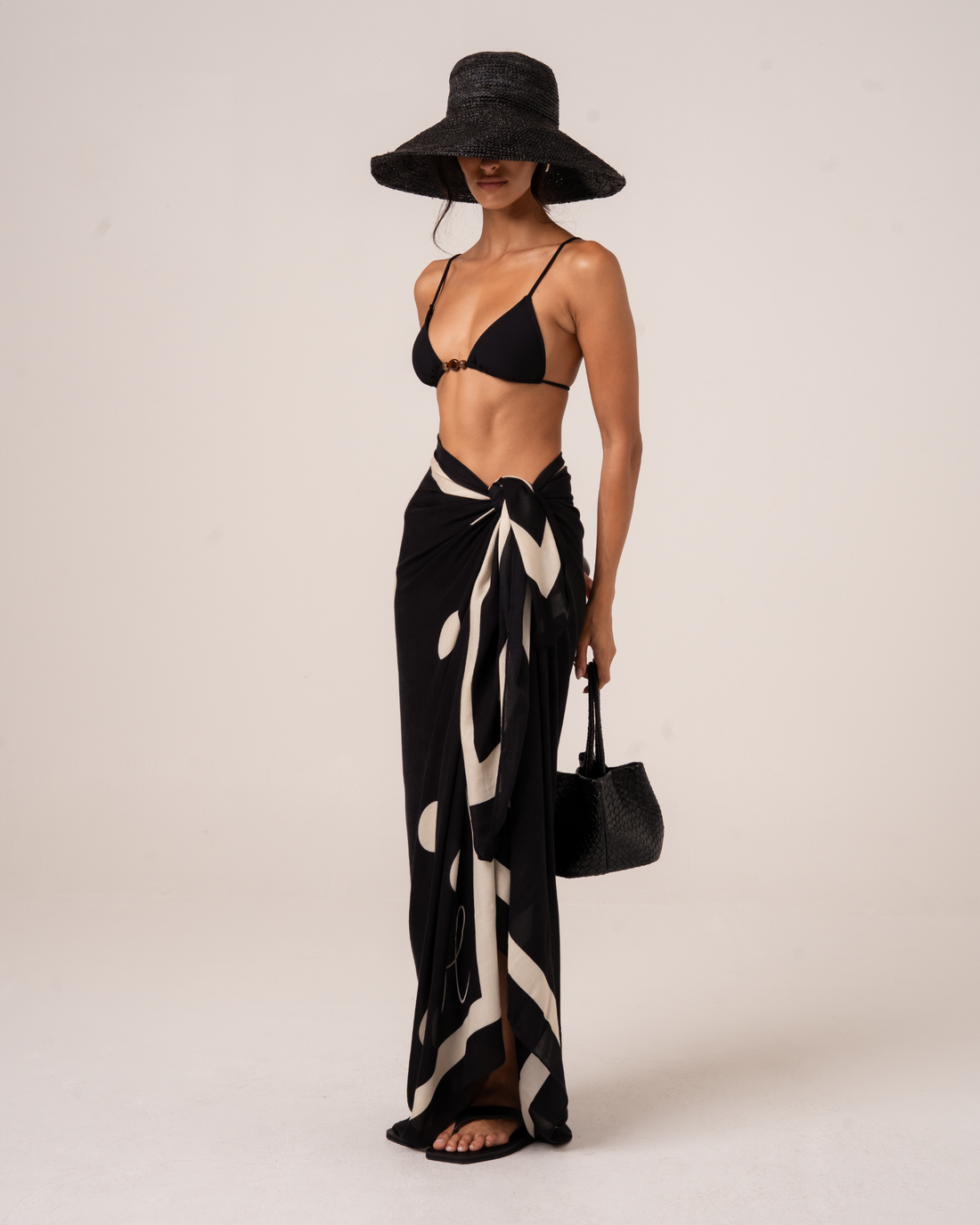 Ochre Lane Noir Dot Sarong in black polkadot print, a lightweight beach cover-up over swimwear