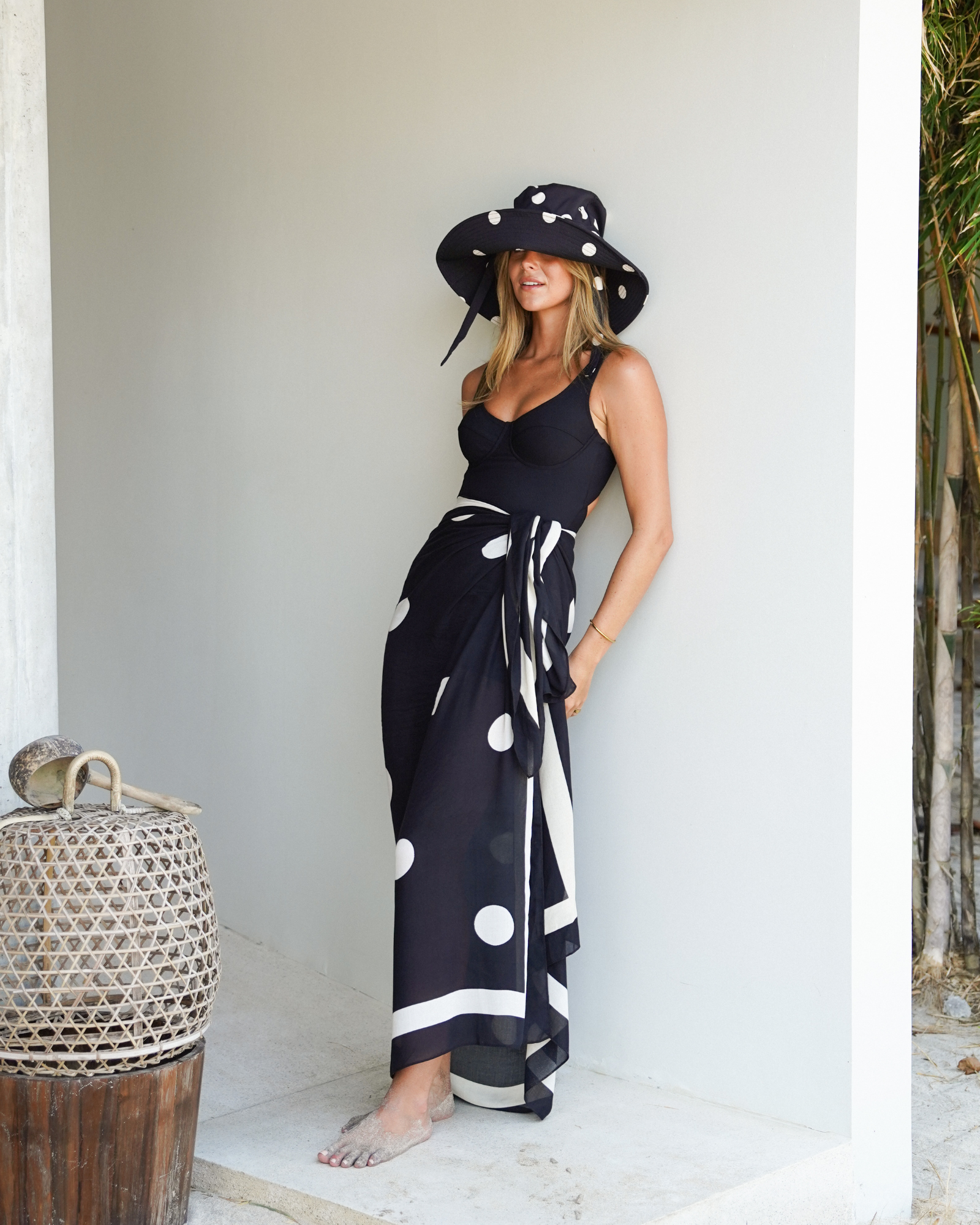Black polkadot Noir Dot Sarong styled as a versatile pareo wrap for resort wear, sizes 8-22