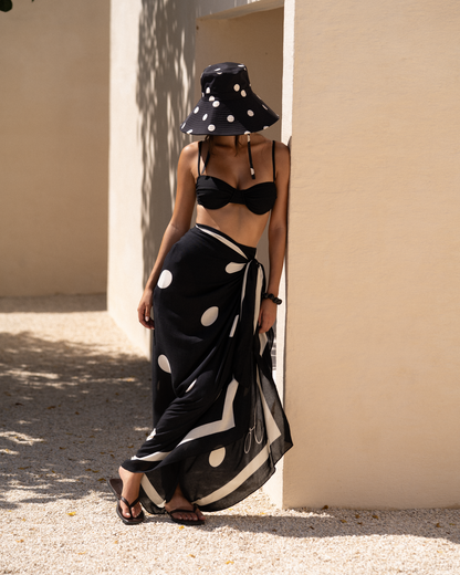 Black polkadot Noir Dot Sarong worn as a versatile pareo wrap for resort styling