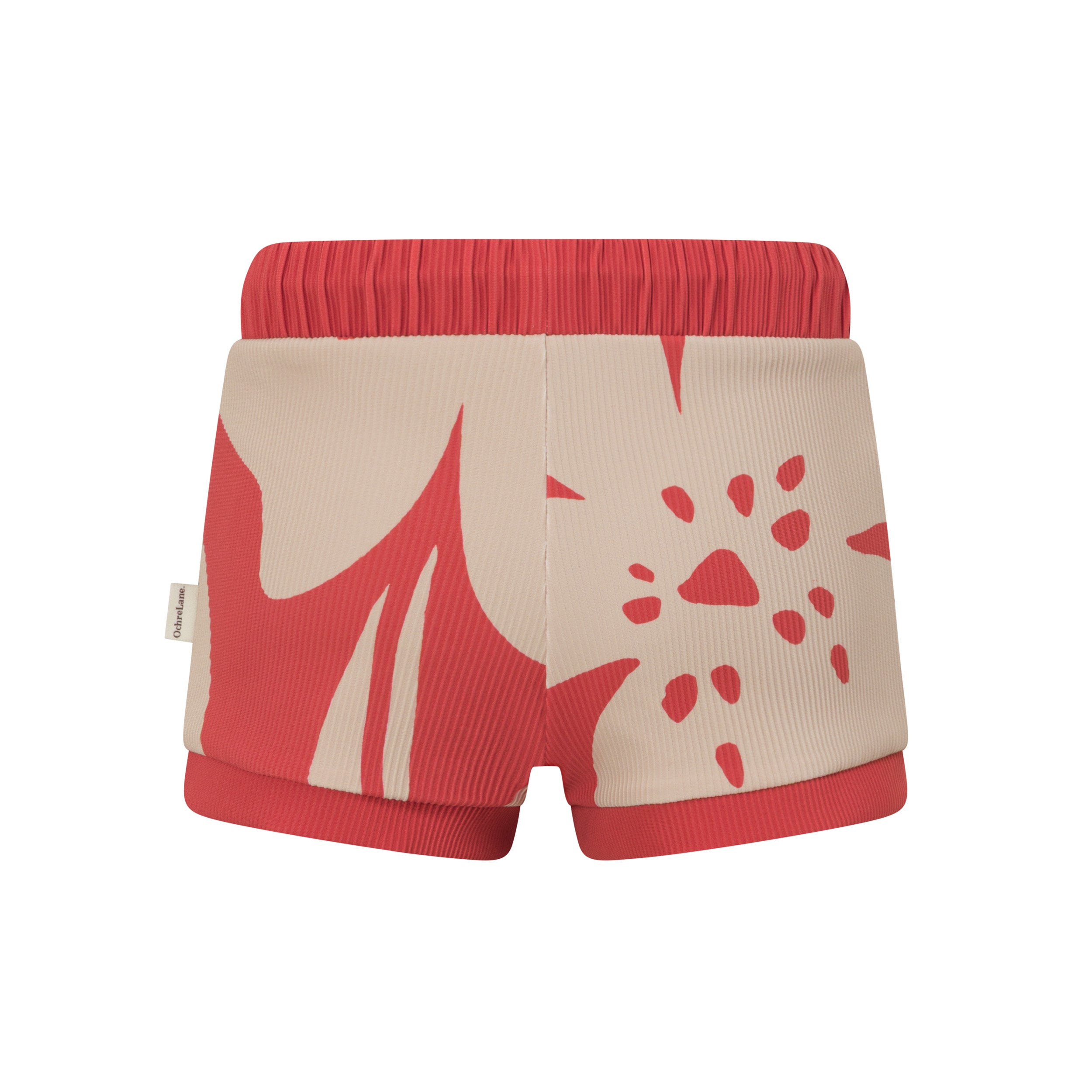 Back view of red kids swim shorts showing the cream hibiscus print and ribbed red cuffs