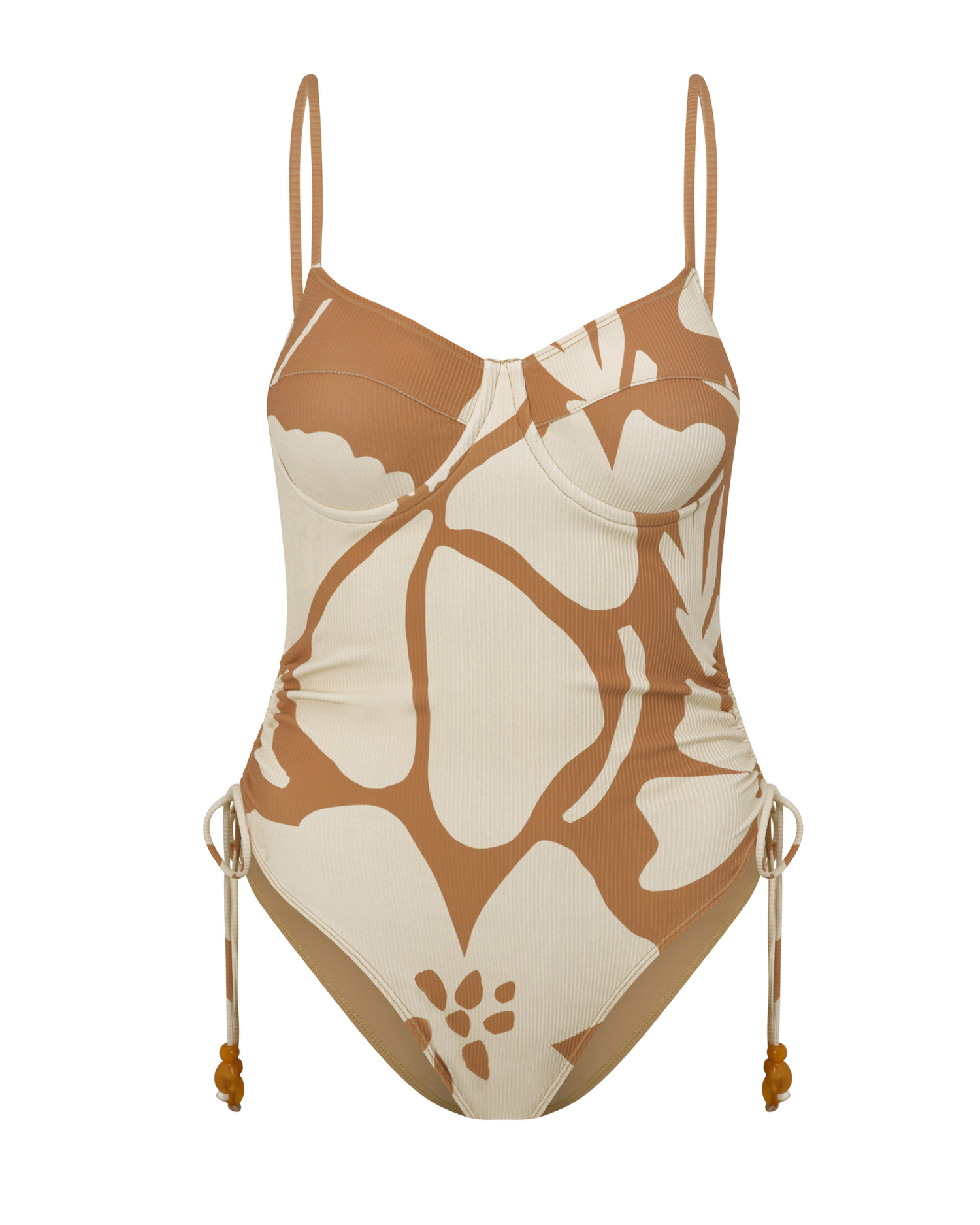 Lifestyle image of the Sienna floral underwire one piece worn at the beach, capturing a relaxed resort aesthetic.