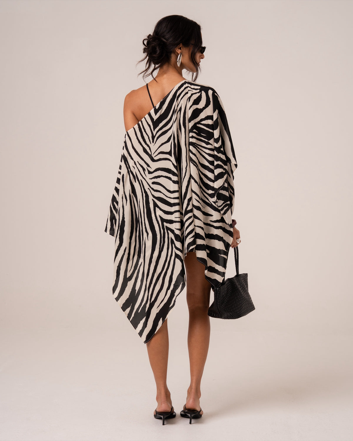 Back view of a zebra print sheer resort cape showing the soft cascading points