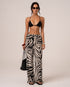 Front view of zebra print wide-leg resort pants with an elasticated drawstring waist, styled with a cropped top
